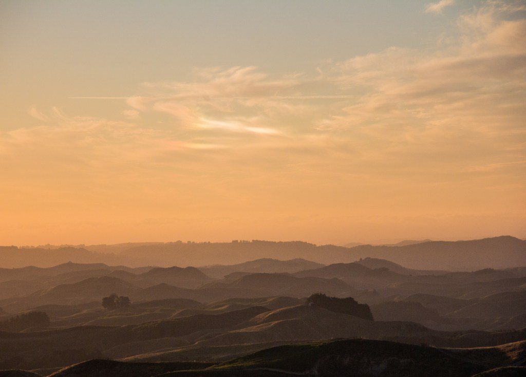Without the ducks, just layers of land and evening cloud, with rainbow type thing.