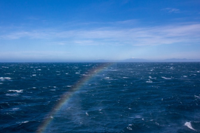 On a rough crossing in Cook Strait, the large bit of water between the North and South Island's you sometimes get these sea spray 'rainbows'. You have to be quick to photograph them as they come and go. Plus you risk a salt water soaking of your camera. You decide if it's worth it. 